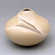 A polished buff jar with an organic opening and an ear of corn applique
 by Iris Nampeyo of Hopi