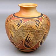 A polychrome jar with a rolled lip and decorated around the body with a migration pattern design
 by James Nampeyo of Hopi
