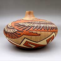 A large polychrome seed pot carved and painted with an Eagle Dancer and Eagle Boy and geometric design, click or tap to see a larger version