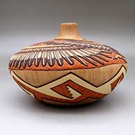 A large polychrome seed pot carved and painted with an Eagle Dancer and Eagle Boy and geometric design, click or tap to see a larger version