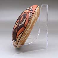 A polychrome mixed clay seed pot decorated on top with a carved, sgraffito and painted masked dancers and geometric design, click or tap to see a larger version