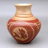 A red on tan triple shouldered jar with a flared rim decorated with a three panel sgraffito butterfly, flower, feather and geometric design
 by Vangie Tafoya of Jemez