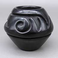 Black jar with a carved geometric design
 by Stella Chavarria of Santa Clara