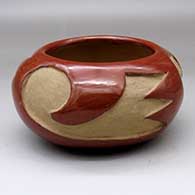 A red bowl carved around the body with a three-panel geometric design
 by Unknown of Santa Clara