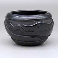 A black bowl decorated with a carved avanyu around the body
 by Clara Shije of Santa Clara