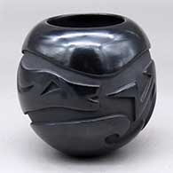A black jar carved around the body with an avanyu design
 by Autumn Borts of Santa Clara