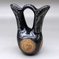 A black wedding vase with sienna spots and decorated with a sgraffito lizard, rabbit, quail, bison, dancer, kiva step and geometric design
 by Mae Tapia of Santa Clara