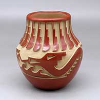 A red jar carved with an avanyu, feather, kiva step and geometric design
 by Anna Archuleta of Santa Clara