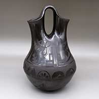 Large black-on-black wedding vase with a flower, kiva step, and geometric design
 by Carmelita Dunlap of San Ildefonso