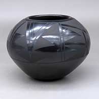 A black on black jar decorated around and above the shoulder with a two-panel geometric design
 by Santanita  Suazo of Santa Clara