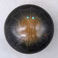 A black seed pot with sienna spots, inlaid stones and a sgraffito moth, spider, spider web and geometric design
 by Barbara Gonzales of San Ildefonso