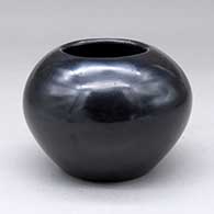 A plain polished black jar
 by Maria Martinez of San Ildefonso