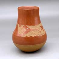 A red with a buff base, decorated with a sgraffito avanyu and geometric design plus an inlaid stone
 by Juan Tafoya of San Ildefonso