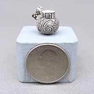 Miniature black-on-white jar with an applique animal and a painted fine line, spiral, checkerboard, and geometric design
 by Thomas Natseway of Laguna