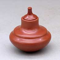 A small plain, double-shouldered, lidded red jar
 by Greg Garcia of Santa Clara