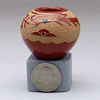 A miniature red jar decorated with an inlaid stone and a sgraffito bird element and geometric design
 by Goldenrod of Santa Clara