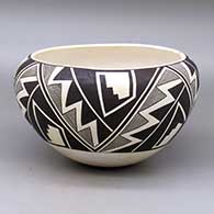 A black on white bowl decorated with a four panel classic Mimbres fineline and geometric design
 by Sarah Garcia of Acoma