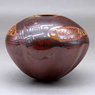 A polychrome jar with a melon base decorated above the shoulder with a three panel sgraffito and painted geometric design, click or tap to see a larger version