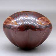 A polychrome jar with a melon base decorated above the shoulder with a three panel sgraffito and painted geometric design, click or tap to see a larger version