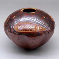 A polychrome jar with a melon base decorated above the shoulder with a three panel sgraffito and painted geometric design
 by Baudel Lopez of Mata Ortiz and Casas Grandes