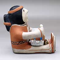 A sitting male drummer figure with a drum and drum stick, click or tap to see a larger version