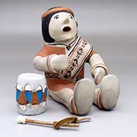 A sitting male drummer figure with a drum and drum stick, click or tap to see a larger version