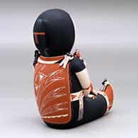 A sitting grandmother storyteller figure with 19 tiny children, click or tap to see a larger version