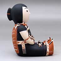 A sitting grandmother storyteller figure with 19 tiny children, click or tap to see a larger version