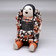 A grandmother storyteller with seventeen children
 by Louise Suina of Cochiti