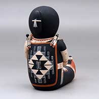 A sitting grandmother storyteller figure with fourteen tiny children, click or tap to see a larger version