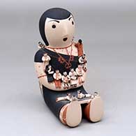 A sitting grandmother storyteller figure with fourteen tiny children
 by Dena Suina of Cochiti