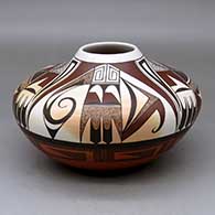 A low shouldered polychrome jar decorated with a four-panel bird element and geometric design above the shoulder and an eight-panel geometric design below the shoulder
 by Charles Navasie of Hopi