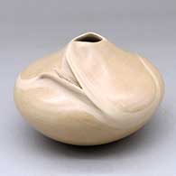 A buff jar with an organic opening and a carved ear of corn applique
 by Iris Nampeyo of Hopi