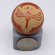 A miniature red seed pot with a sgraffito dragonfly and geometric design
 by Glendora Fragua of Jemez