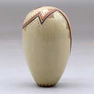 A miniature polychrome seed pot decorated with a lightly carved, sgraffito and painted yeibichai, arrow, rainbow and geometric design, with one inlaid stone, click or tap to see a larger version