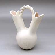 A white wedding vase decorated with a bear paw imprint and a twisted bridge
 by Andrew Padilla of Laguna