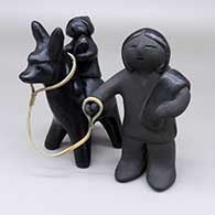 Two-piece black Flight to Egypt figure set with a leather rein detail
 by Dorothy Gutierrez of Santa Clara