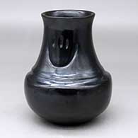 A black double-shouldered jar decorated with two bear paw imprints on the neck
 by Sharon Naranjo Garcia of Santa Clara