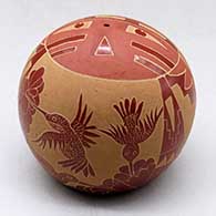 A red seed pot decorated with a sgraffito sunface, hummingbird, flower, feather and geometric design, click or tap to see a larger version