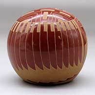 A red seed pot decorated with a sgraffito sunface, hummingbird, flower, feather and geometric design, click or tap to see a larger version