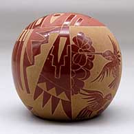 A red seed pot decorated with a sgraffito sunface, hummingbird, flower, feather and geometric design, click or tap to see a larger version