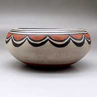 A polychrome bowl decorated on the outside with a cloud geometric design and inside with a bird and geometric design, click or tap to see a larger version
