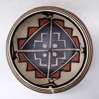 A polychrome bowl decorated on the outside with a cloud geometric design and inside with a bird and geometric design, click or tap to see a larger version