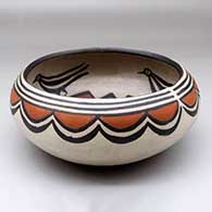 A polychrome bowl decorated on the outside with a cloud geometric design and inside with a bird and geometric design
 by Robert Tenorio of Santo Domingo