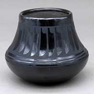 A black on black jar decorated with a ring of feathers design above the shoulder
 by Adam and Santana Martinez of San Ildefonso