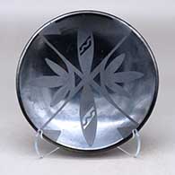 A black on black plate decorated with a geometric design
 by Adam and Santana Martinez of San Ildefonso