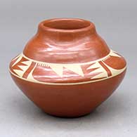 A buff on red double-shouldered jar decorated with a four-panel geometric design between the shoulders
 by Kathy Gutierrez of San Ildefonso