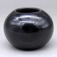A plain black polished bowl
 by Maria Martinez of San Ildefonso