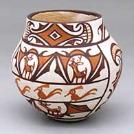 A small polychrome jar decorated with a four-panel deer-in-his-house, rainbird and geometric design,.
 by Jennie Laate of Zuni