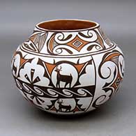A polychrome jar decorated with a four panel deer in his house, rainbird, fineline and geometric design
 by Noreen Simplicio of Zuni